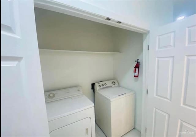 washroom with washing machine and clothes dryer