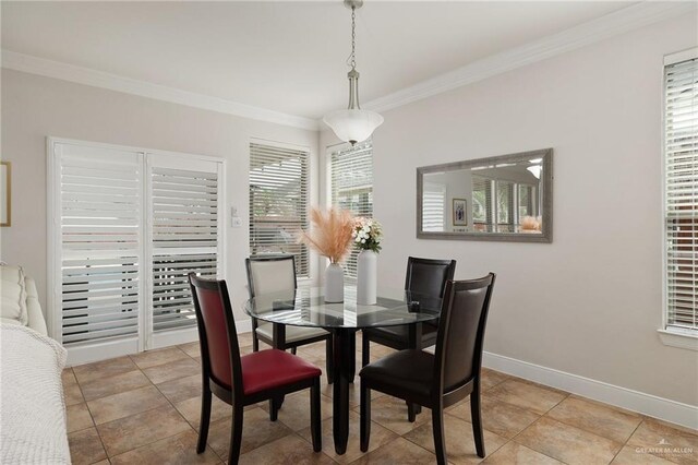 dining room featuring light tile patterned floors, ornamental molding, and baseboards