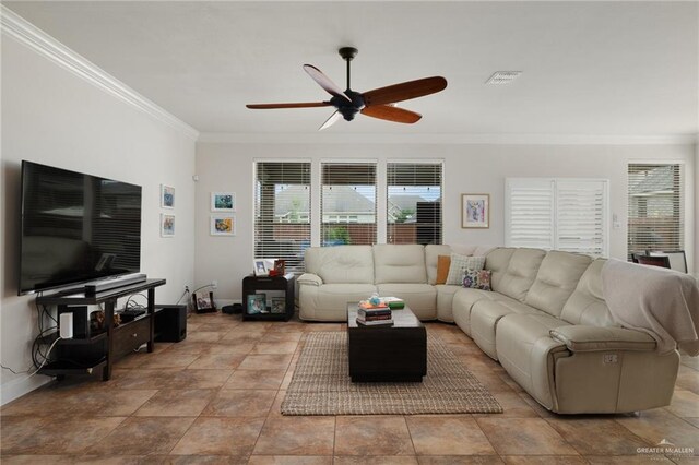 living room featuring visible vents, ceiling fan, crown molding, and baseboards