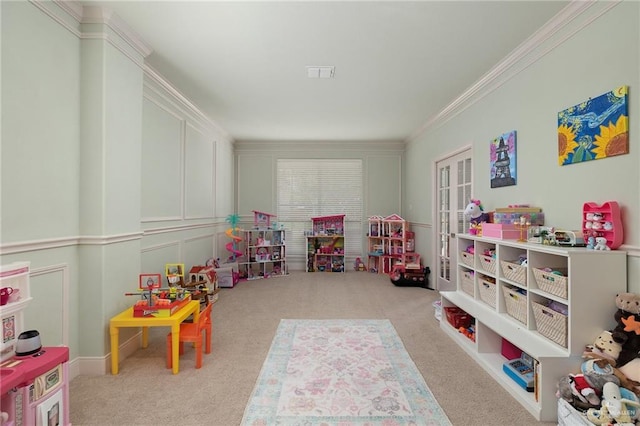 recreation room with visible vents, crown molding, and carpet flooring