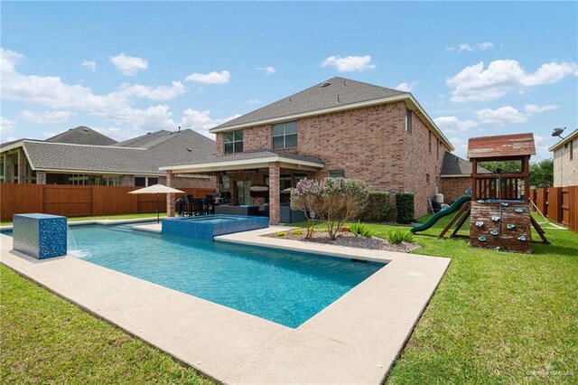 view of pool with a fenced backyard, a yard, a patio, a pool with connected hot tub, and a playground