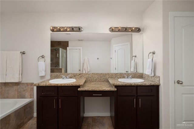 full bath with double vanity, a stall shower, and a sink