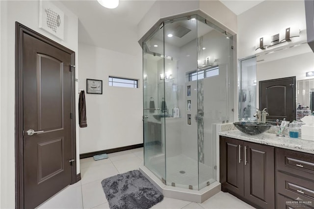 full bathroom with baseboards, a shower stall, vanity, and tile patterned floors