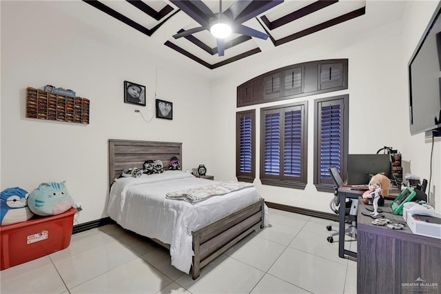 bedroom featuring beam ceiling, light tile patterned floors, a ceiling fan, coffered ceiling, and baseboards