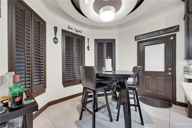 dining area with baseboards and light tile patterned floors