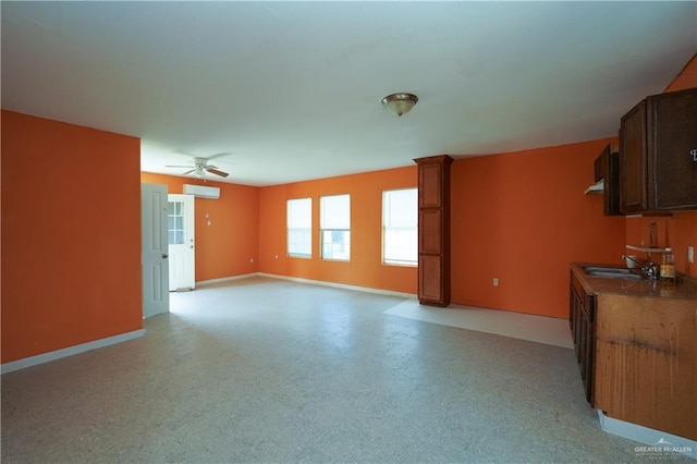 24834 Birch St, San Benito, TX 78586 - unfurnished living room with a sink, a ceiling fan, and baseboards