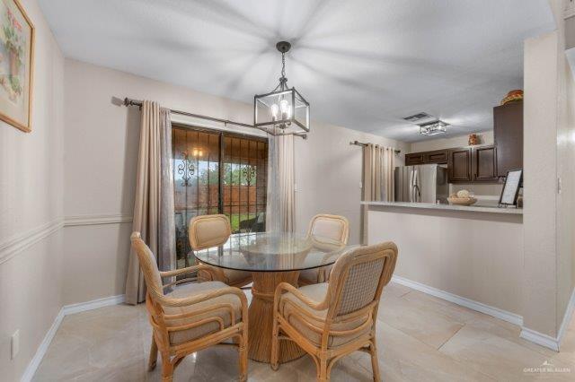 dining area with an inviting chandelier