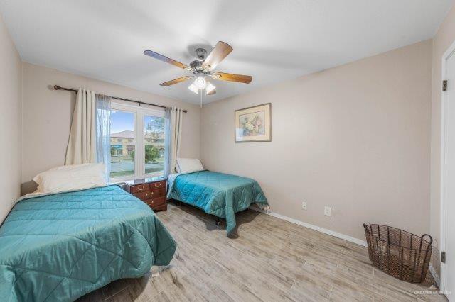 bedroom featuring ceiling fan and light hardwood / wood-style flooring