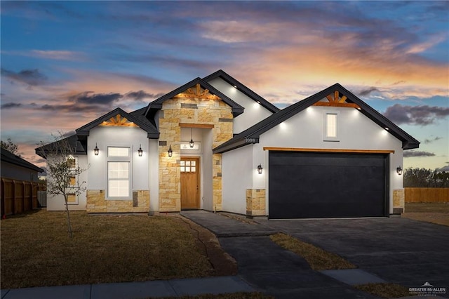 1008 Magnolia St, Mission, TX 78573 - view of front of house with stone siding, asphalt driveway, stucco siding, and an attached garage