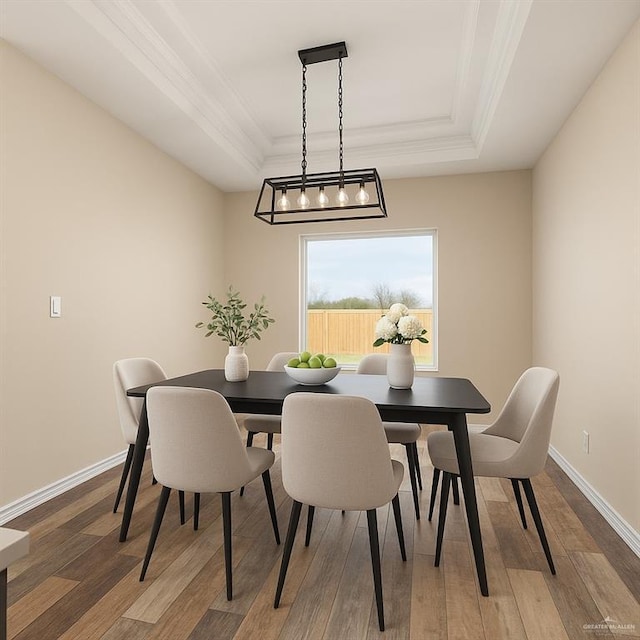 1008 Magnolia St, Mission, TX 78573 - dining room with a raised ceiling, light wood finished floors, crown molding, and baseboards