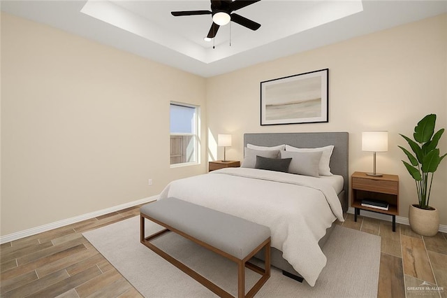 1008 Magnolia St, Mission, TX 78573 - bedroom featuring a raised ceiling, wood finished floors, baseboards, and ceiling fan