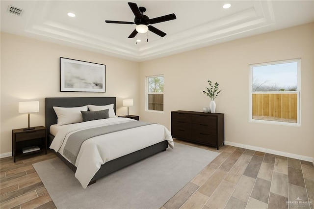1008 Magnolia St, Mission, TX 78573 - bedroom featuring a raised ceiling, recessed lighting, light wood-style floors, baseboards, and ceiling fan