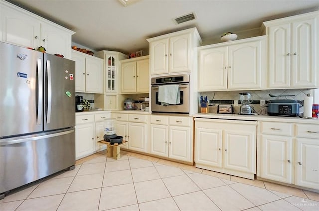 4010 Blackhawk St, Edinburg, TX 78539 - kitchen featuring stainless steel appliances, decorative backsplash, light tile patterned flooring, and light countertops