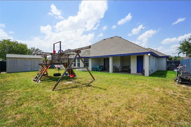 4010 Blackhawk St, Edinburg, TX 78539 - rear view of house featuring a playground, a storage shed, and a shingled roof