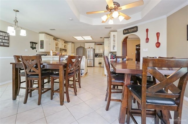 4010 Blackhawk St, Edinburg, TX 78539 - dining room featuring arched walkways, a raised ceiling, light tile patterned floors, ceiling fan, and ornamental molding