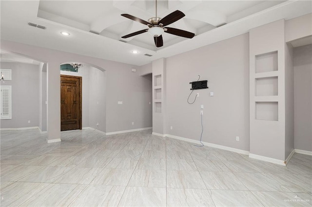 unfurnished room with built in shelves and ceiling fan