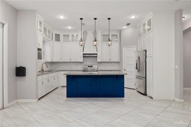 kitchen with pendant lighting, a center island, white cabinets, and stainless steel appliances