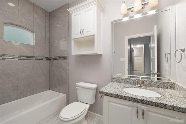 full bathroom featuring vanity, toilet, and tiled shower / bath