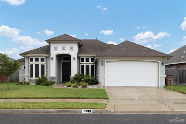 view of front of property featuring a front yard and a garage