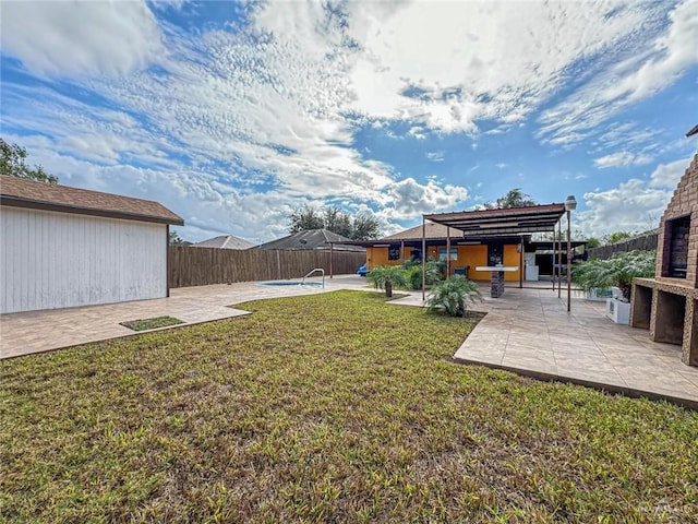 view of yard with a fireplace, a patio, and a pool