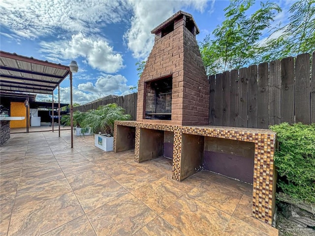 view of patio / terrace with exterior fireplace