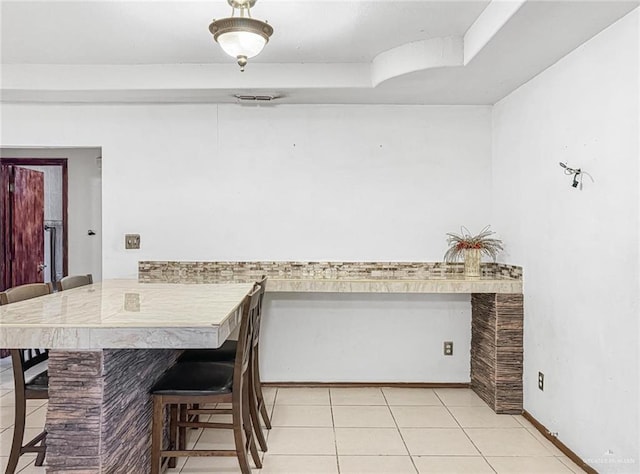 dining area featuring light tile patterned floors