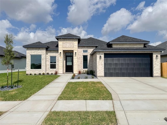 3807 Crimson St, Mission, TX 78574 - view of front of home featuring an attached garage, driveway, roof with shingles, and brick siding