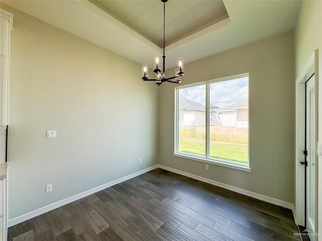 3807 Crimson St, Mission, TX 78574 - spare room with a chandelier, dark wood finished floors, baseboards, and a tray ceiling
