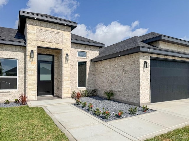 3807 Crimson St, Mission, TX 78574 - view of front facade featuring an attached garage, stone siding, and a shingled roof