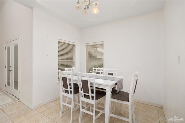 dining area featuring a notable chandelier and light tile patterned floors