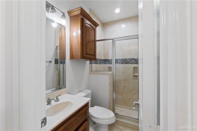 bathroom featuring toilet, an enclosed shower, and vanity