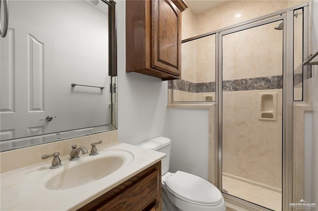 bathroom with vanity, an enclosed shower, and toilet