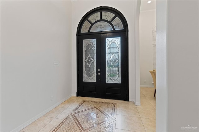 entryway with light tile patterned floors and french doors