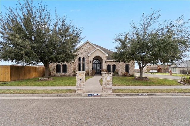 view of front of house featuring french doors and a front yard