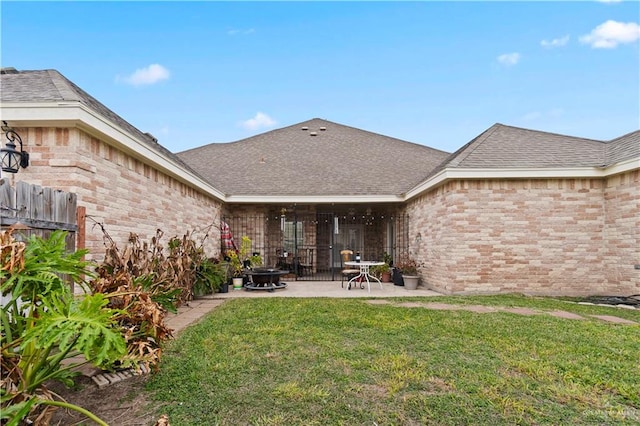 rear view of property with a patio area and a lawn