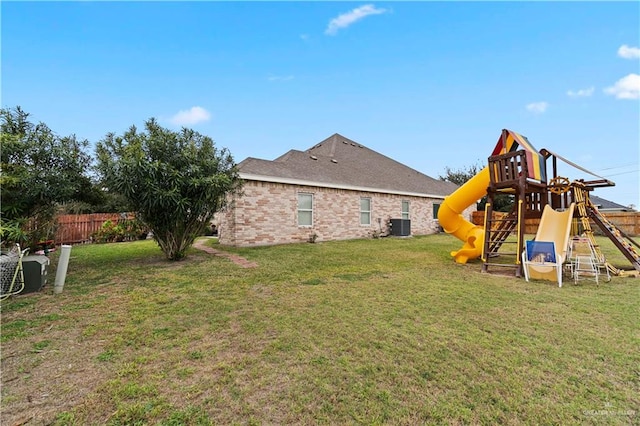 view of yard with central AC and a playground