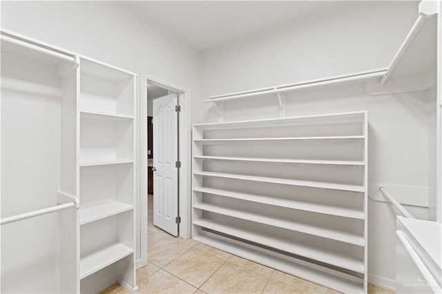 spacious closet featuring light tile patterned floors