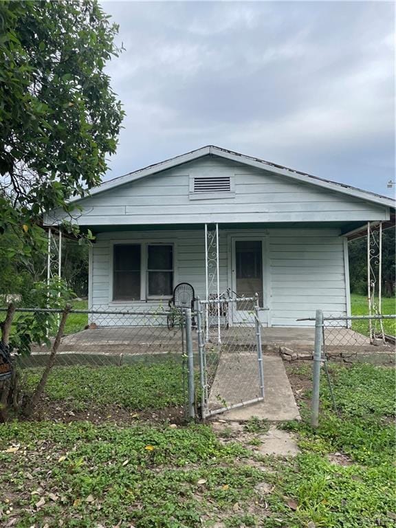 408 E Gardenia Ave, Hidalgo, TX 78557 - view of front of house featuring covered porch, a gate, and a fenced front yard