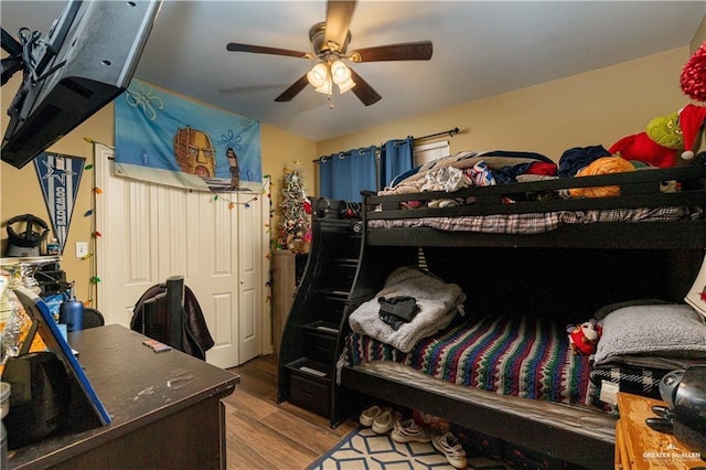 bedroom with a ceiling fan and wood finished floors