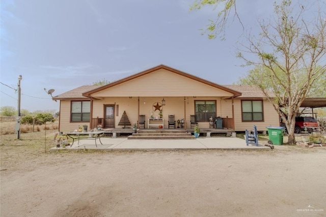 back of property with covered porch