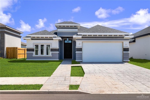 prairie-style house featuring a garage and a front yard