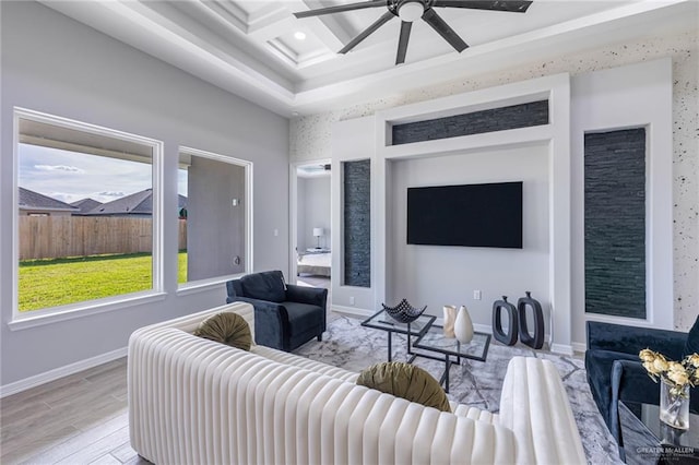 living room featuring ceiling fan, beamed ceiling, light hardwood / wood-style floors, and coffered ceiling