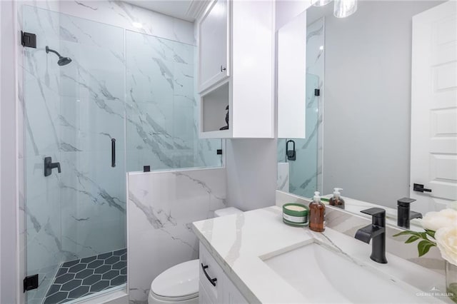 bathroom featuring vanity, toilet, and a shower with shower door