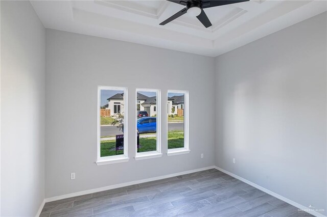 spare room featuring hardwood / wood-style floors, ceiling fan, and coffered ceiling