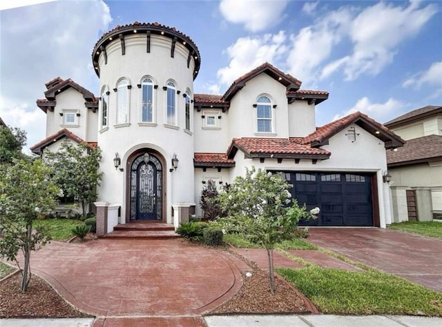 mediterranean / spanish-style house with a garage