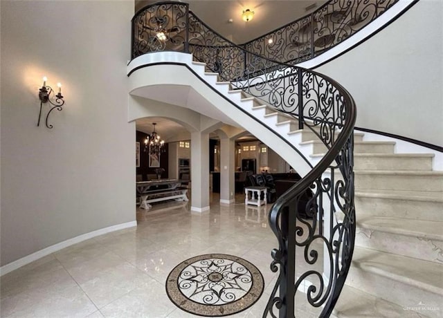 entrance foyer with an inviting chandelier and a towering ceiling