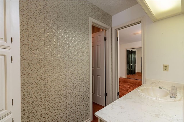 corridor with dark hardwood / wood-style floors and sink