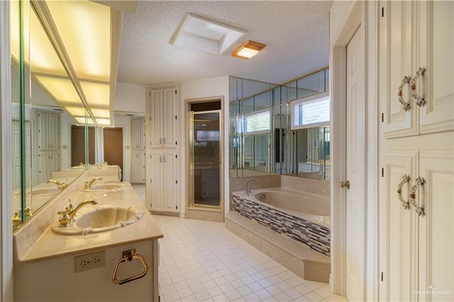 bathroom featuring tile patterned flooring, vanity, independent shower and bath, and a textured ceiling