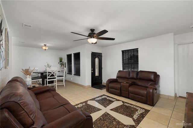 2113 W Harrison St, Weslaco, TX 78599 - living room featuring light tile patterned floors, a ceiling fan, and baseboards