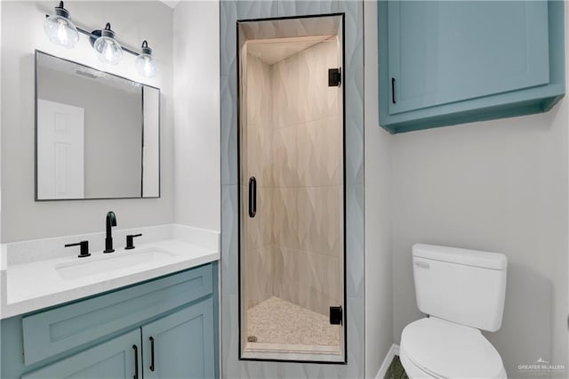 bathroom with vanity, a shower with shower door, and toilet